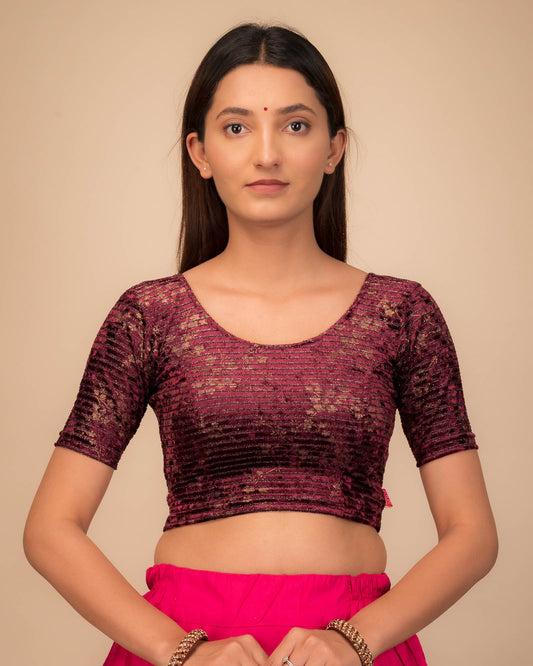 Model wearing a velvet stretchable blouse with elbow sleeves and round neckline.
