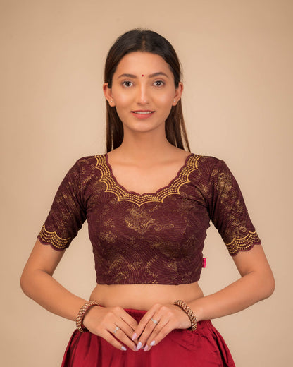 Model wearing a stretchable blouse with elbow sleeves and round neckline, featuring floral embroidery with stone accents.