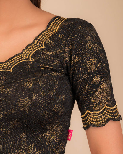 Close-up of jacquard fabric detailing the intricate embroidery and stones.