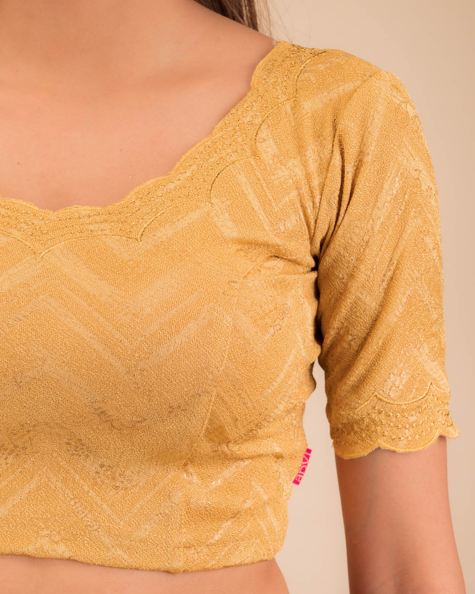 Close-up of jacquard fabric detailing the intricate embroidery and stones.