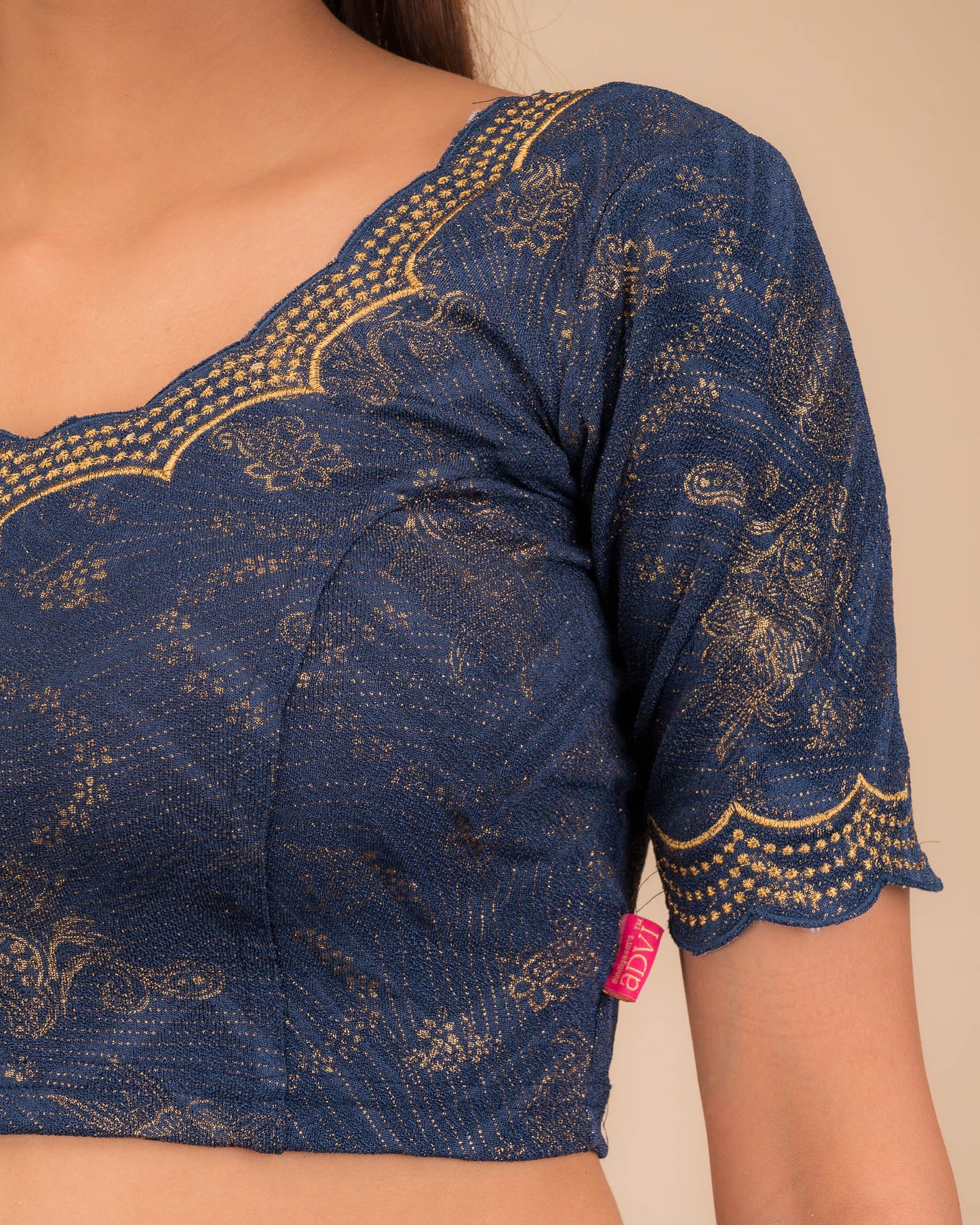 Close-up of jacquard fabric detailing the intricate embroidery and stones.