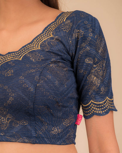 Close-up of jacquard fabric detailing the intricate embroidery and stones.