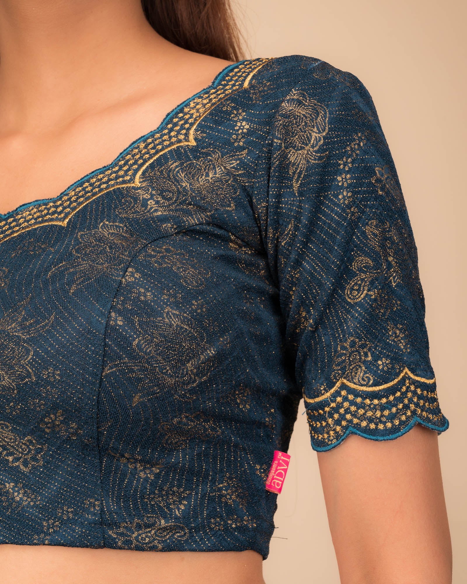 Close-up of jacquard fabric detailing the intricate embroidery and stones.
