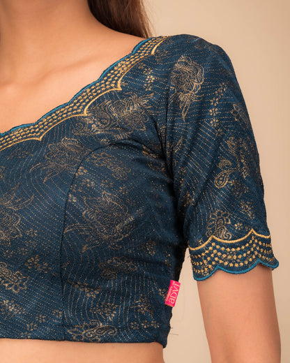 Close-up of jacquard fabric detailing the intricate embroidery and stones.