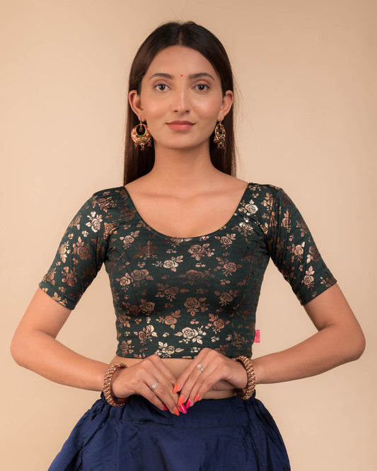 Model wearing a stretchable blouse with elbow sleeves and round neckline, featuring metallic foil floral print.