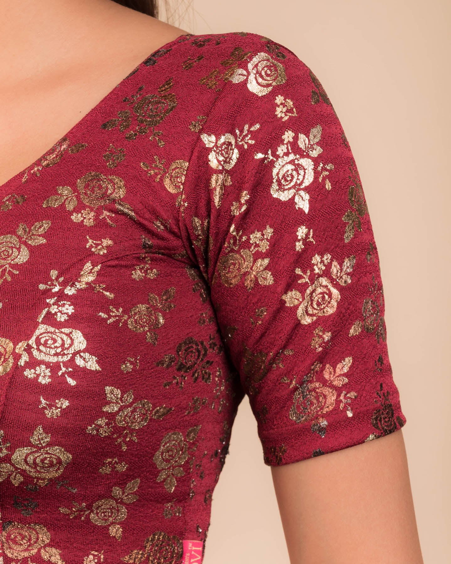 Close-up of the textured fabric with foil floral detailing.