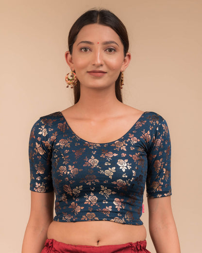 Model wearing a stretchable blouse with elbow sleeves and round neckline, featuring metallic foil floral print.