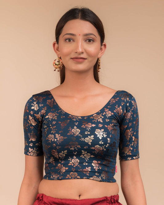 Model wearing a stretchable blouse with elbow sleeves and round neckline, featuring metallic foil floral print.