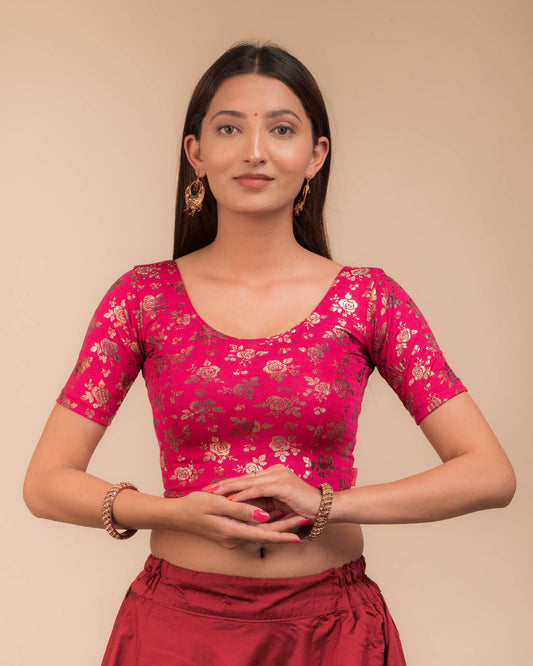 Model wearing a stretchable blouse with elbow sleeves and round neckline, featuring metallic foil floral print.