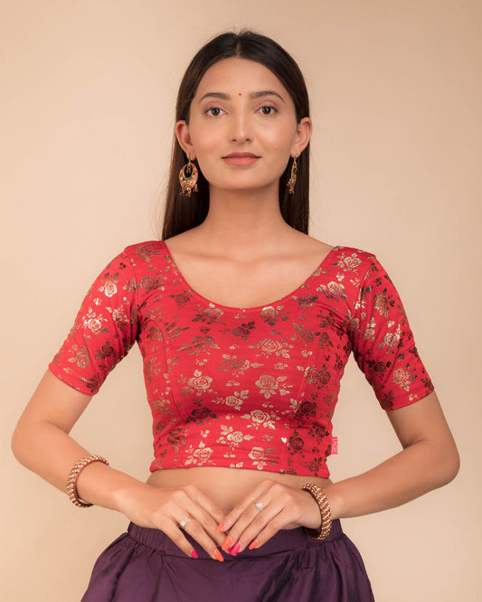 Model wearing a stretchable blouse with elbow sleeves and round neckline, featuring metallic foil floral print.