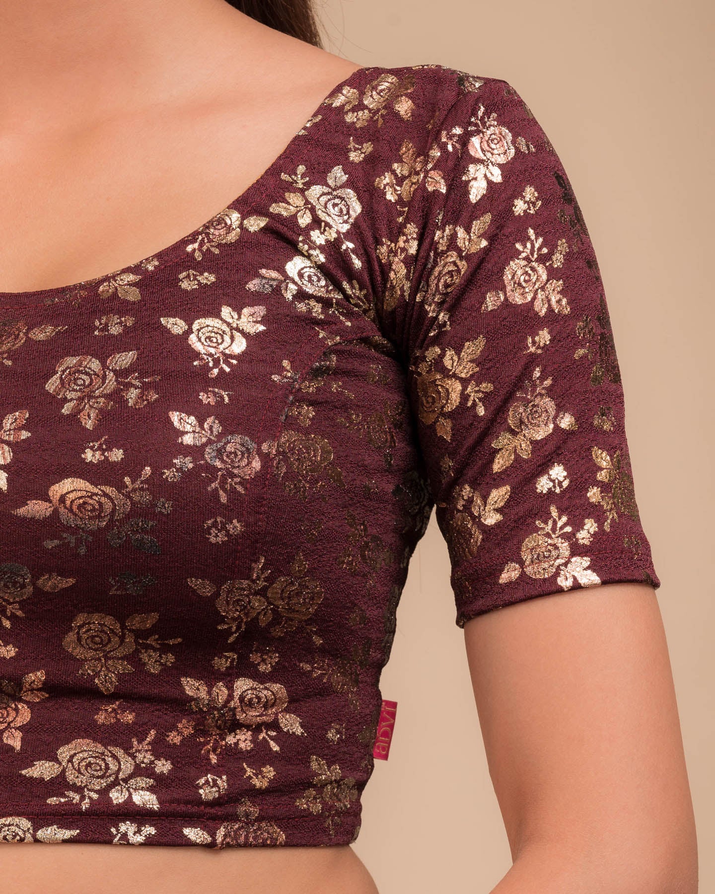 Close-up of the textured fabric with foil floral detailing.