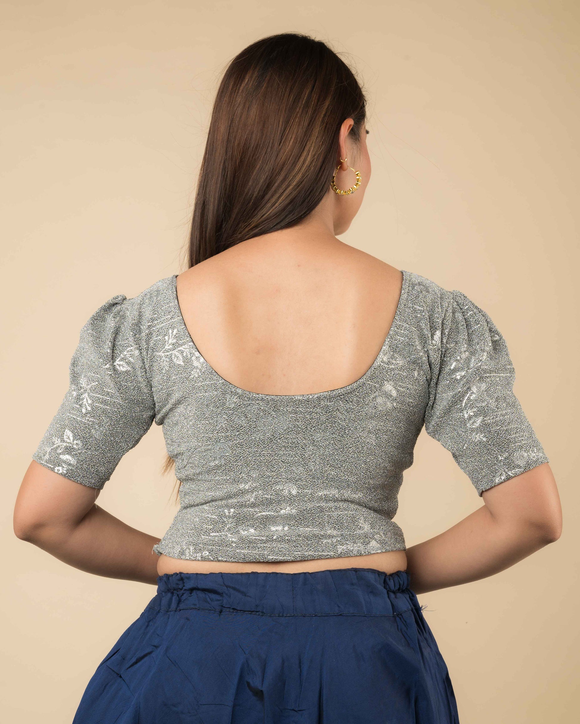 Rear view of the metallic blouse highlighting embossed design and flattering fit.
