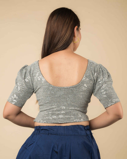 Rear view of the metallic blouse highlighting embossed design and flattering fit.