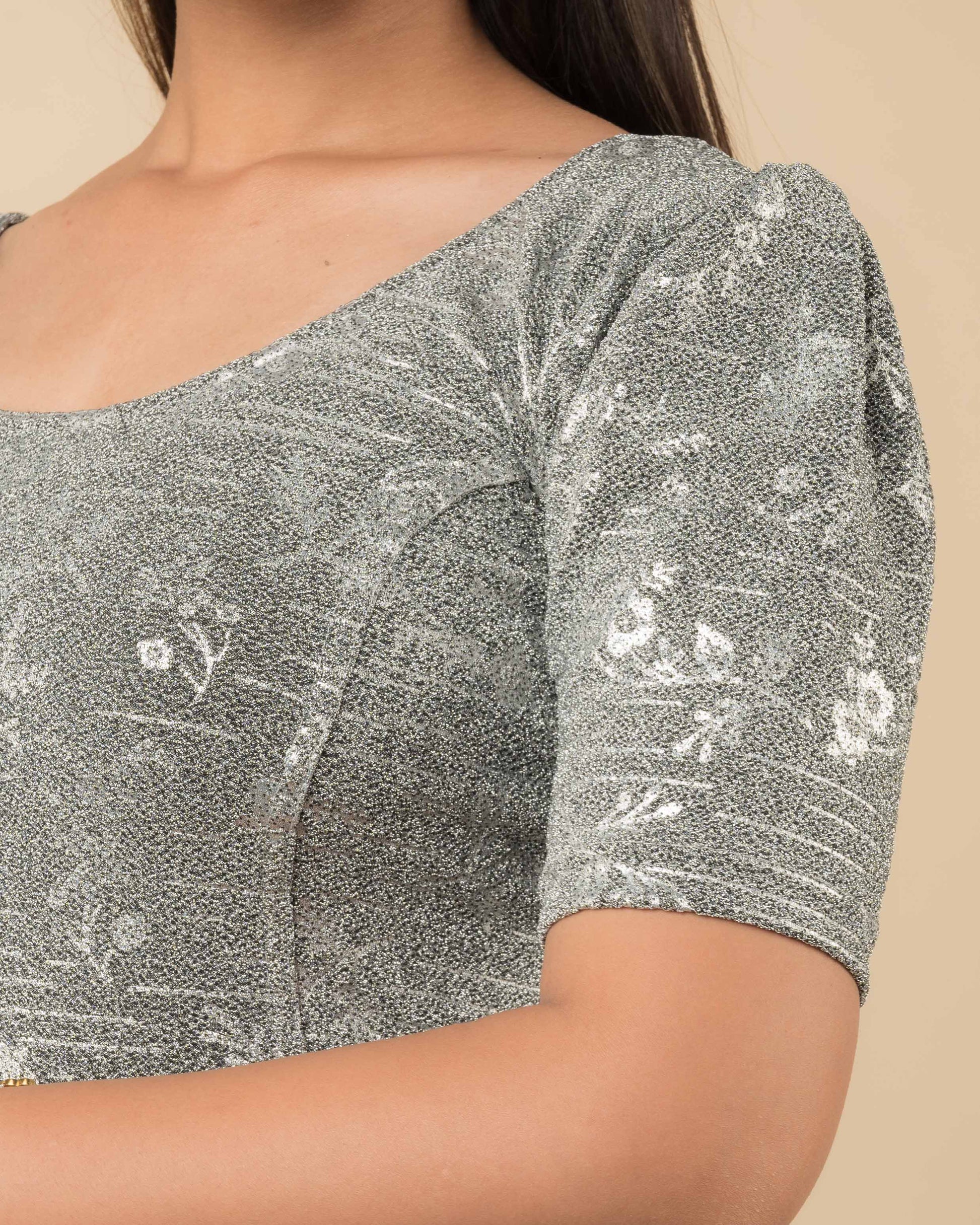 Close-up of the metallic jacquard fabric showing embossed detailing.