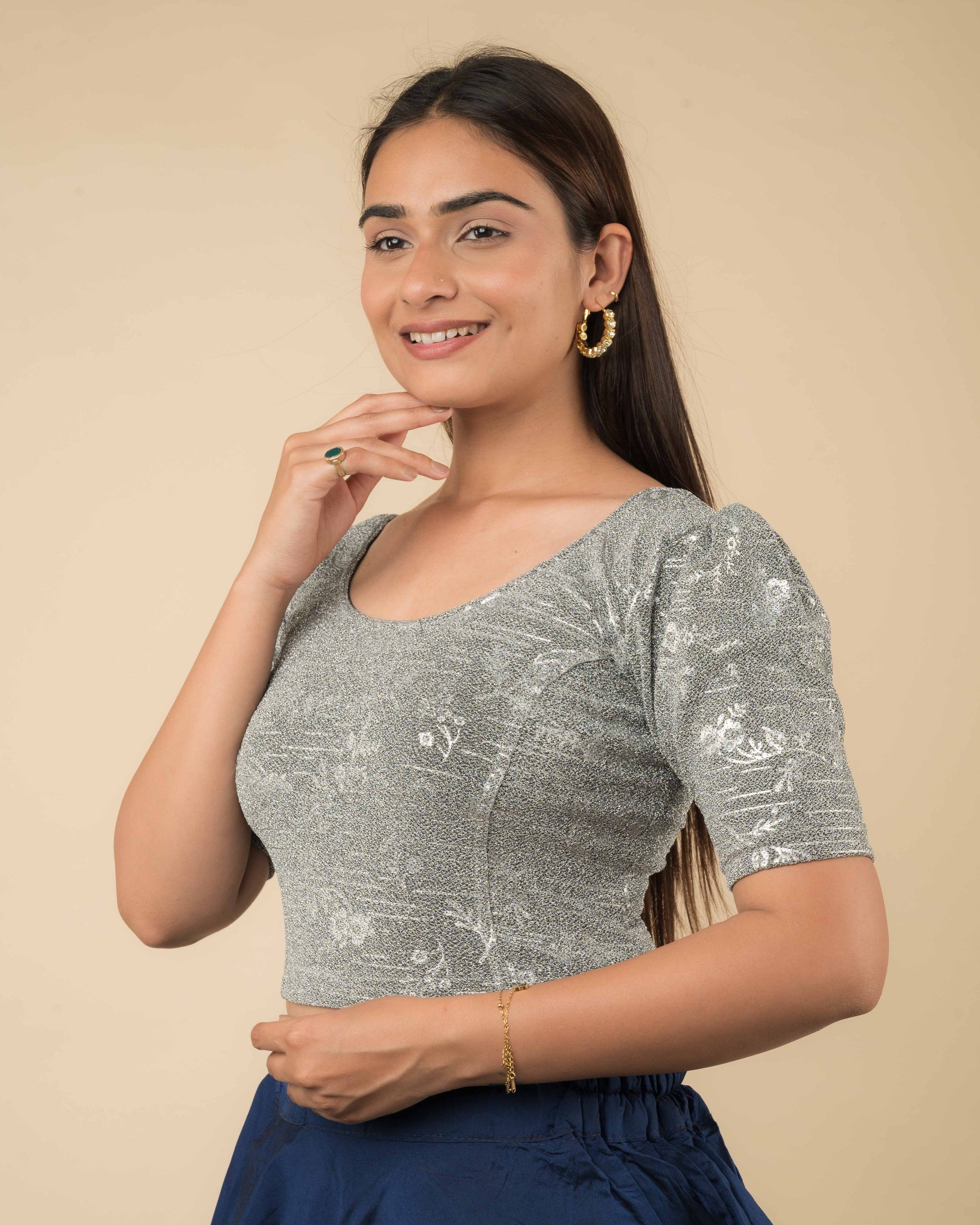 Side angle showcasing the puff sleeves, tailored shape, and textured shimmer.
