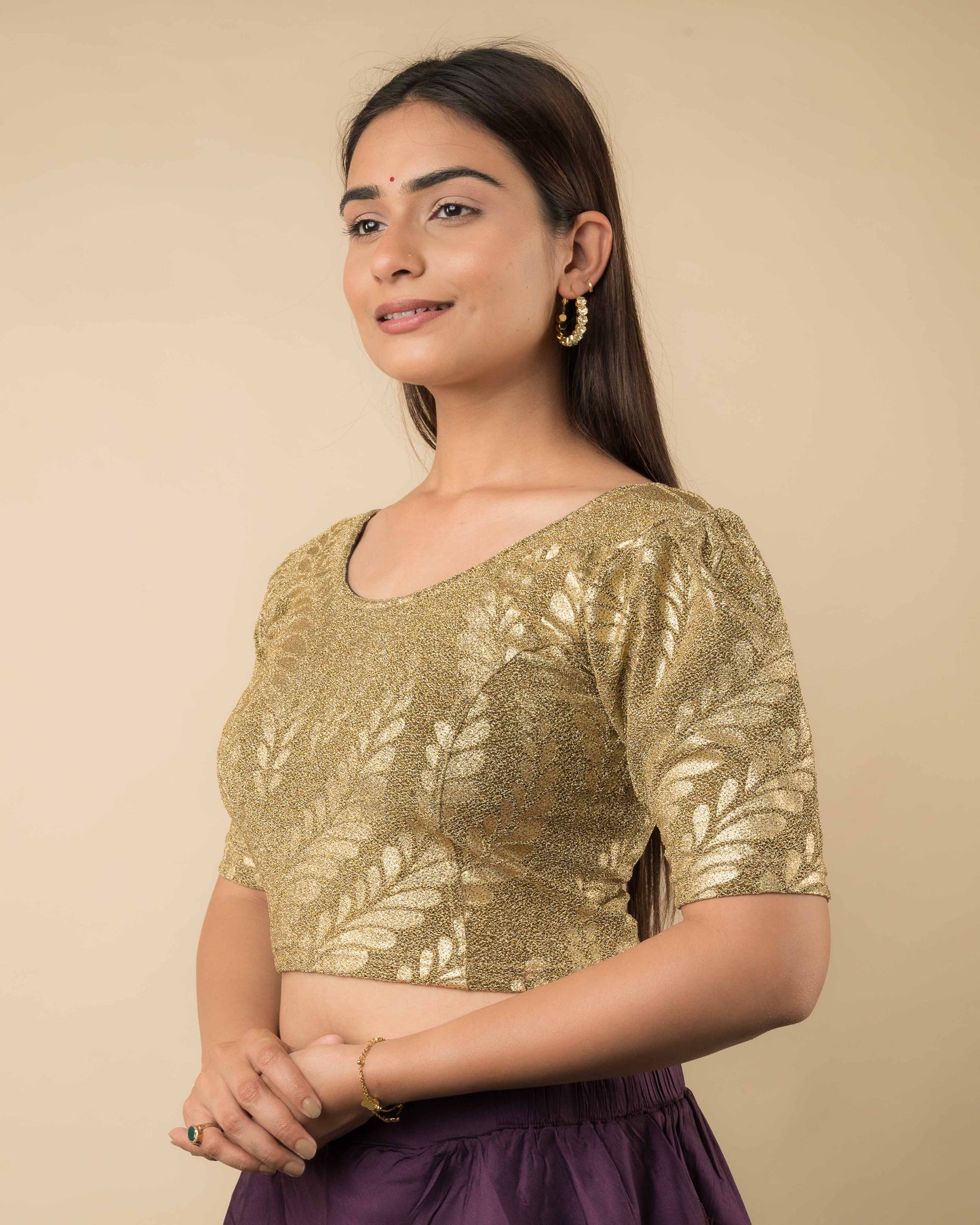 Side angle showcasing the puff sleeves, tailored shape, and textured shimmer.