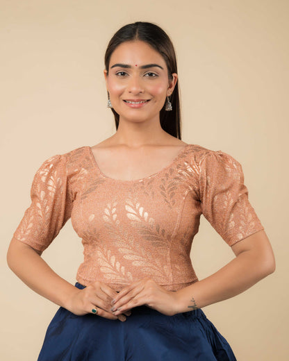 Model wearing metallic zari stretchable blouse with rose print, round neck and elbow sleeves, styled for festive sarees.