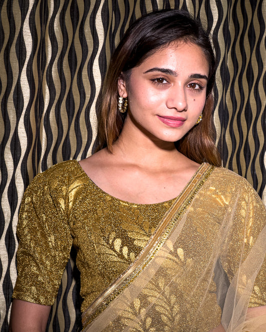 Model pairing metallic zari stretchable blouse with saree for a festive ethnic look.
