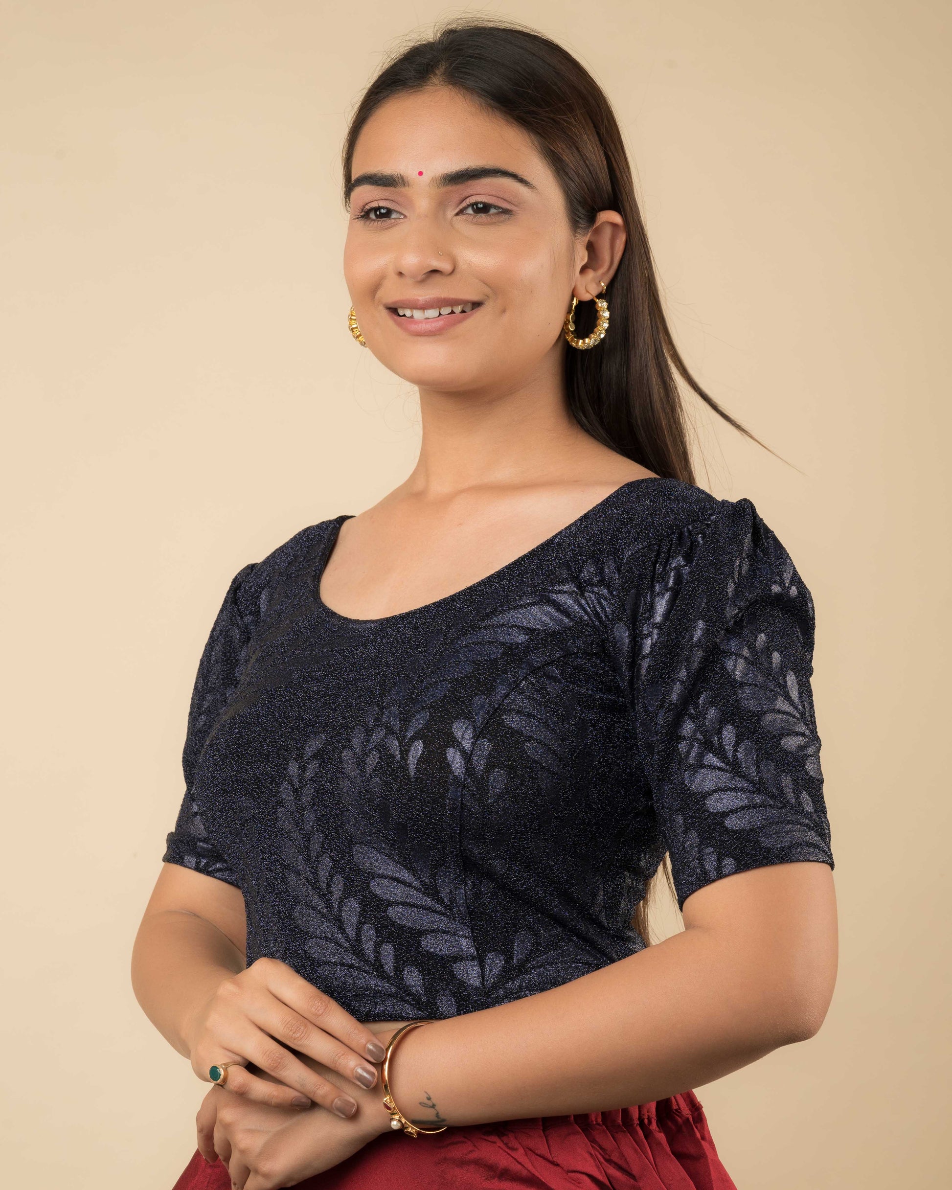 Side profile of bright gold metallic zari stretchable blouse showing sleeve and body fit.