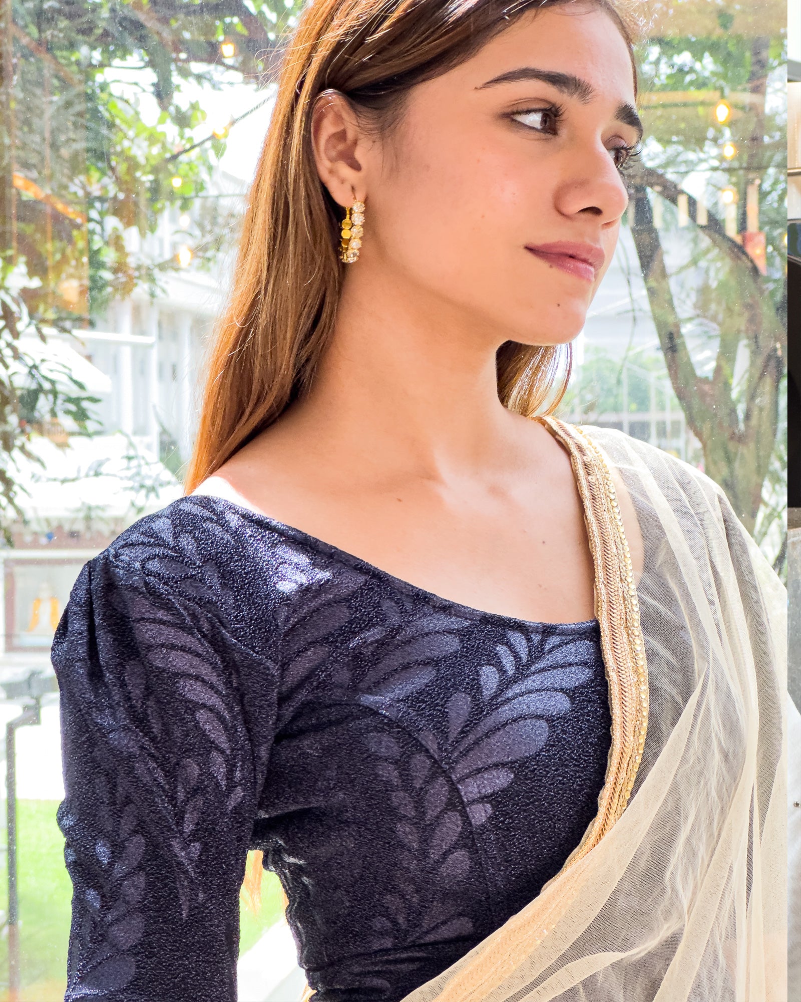 Model pairing bright gold metallic zari stretchable blouse with traditional saree, demonstrating festive ethnic look.
