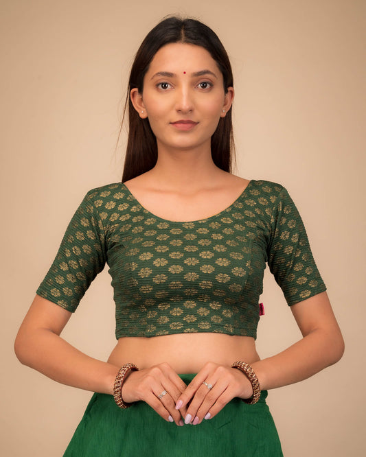 Model wearing a stretchable blouse with elbow sleeves and round neckline featuring foil floral detailing.