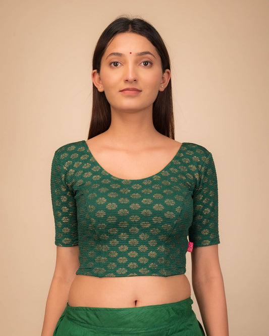 Model wearing a stretchable blouse with elbow sleeves and round neckline featuring foil floral detailing.