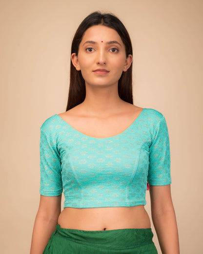 Model wearing a stretchable blouse with elbow sleeves and round neckline featuring foil floral detailing.