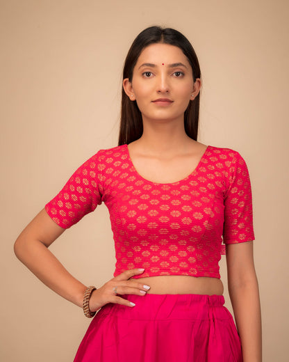 Model wearing a stretchable blouse with elbow sleeves and round neckline featuring foil floral detailing.