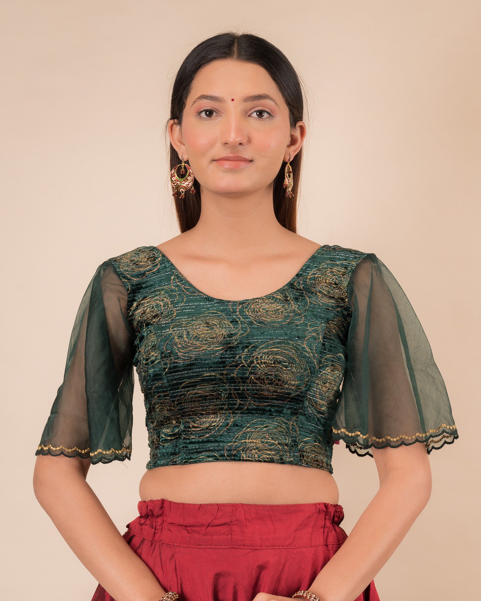 Model wearing a velvet slip-on blouse with elbow bell sleeves and round neckline.