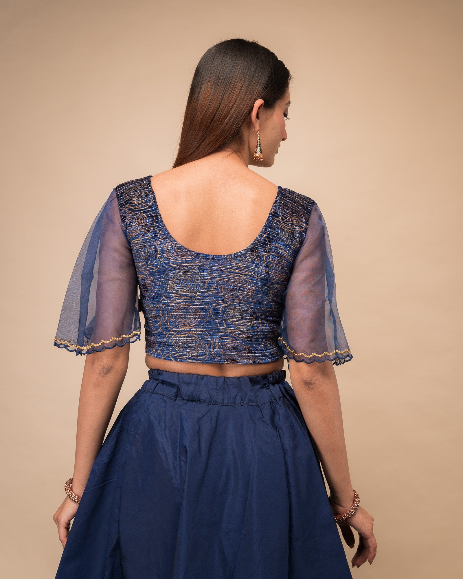 Rear view showcasing the layered bell sleeve detail.