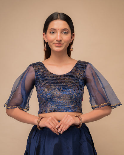 Model wearing a velvet slip-on blouse with elbow bell sleeves and round neckline.