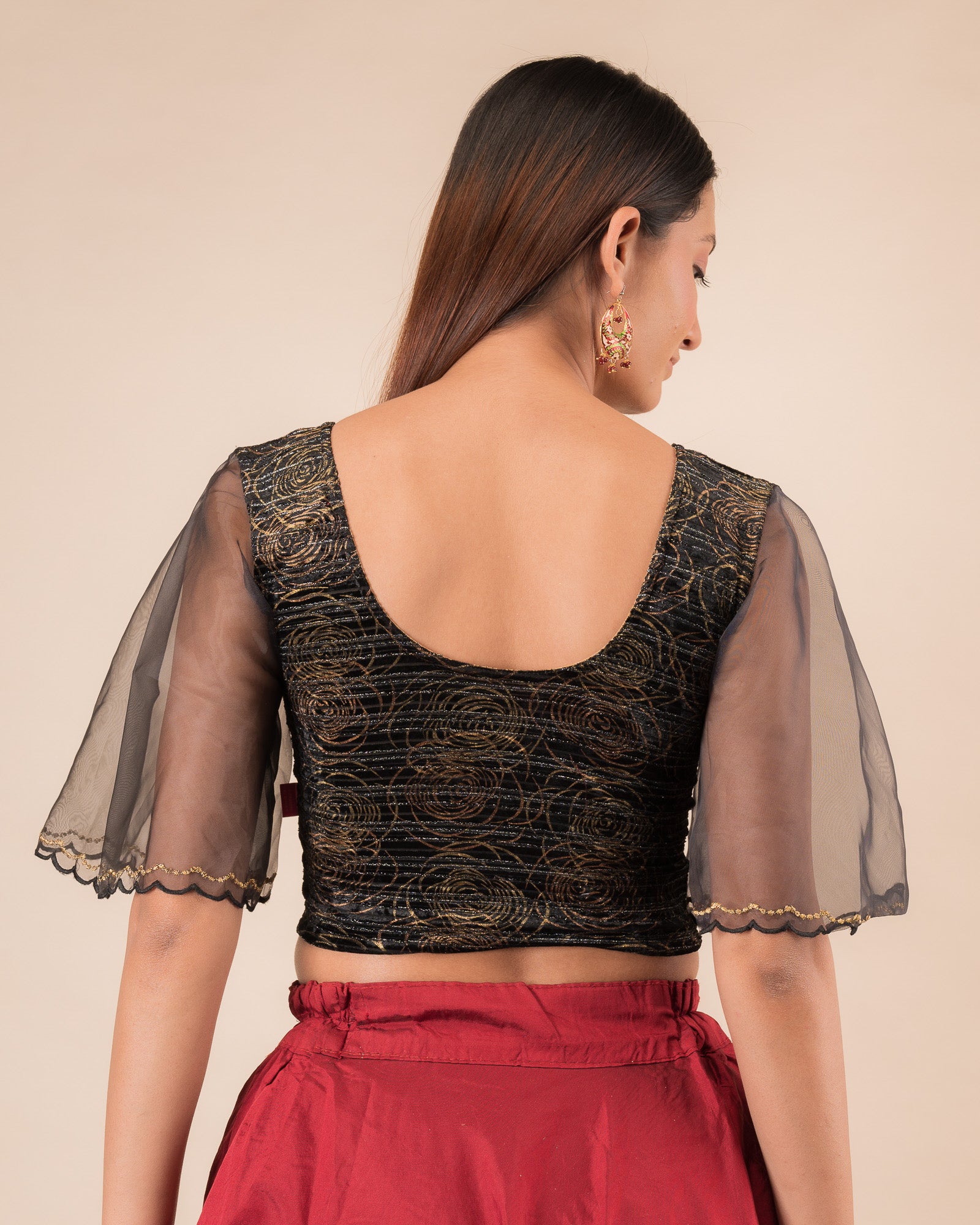 Rear view showcasing the layered bell sleeve detail.