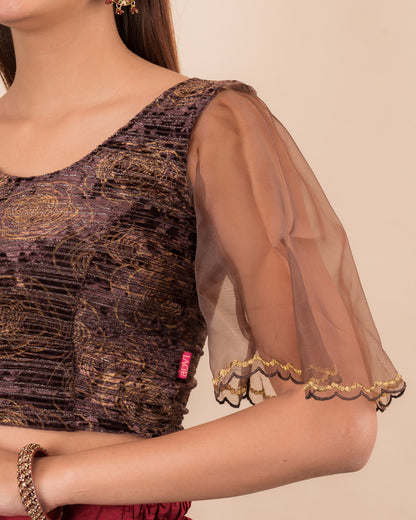 Close-up of velvet fabric and embroidered organza sleeve.
