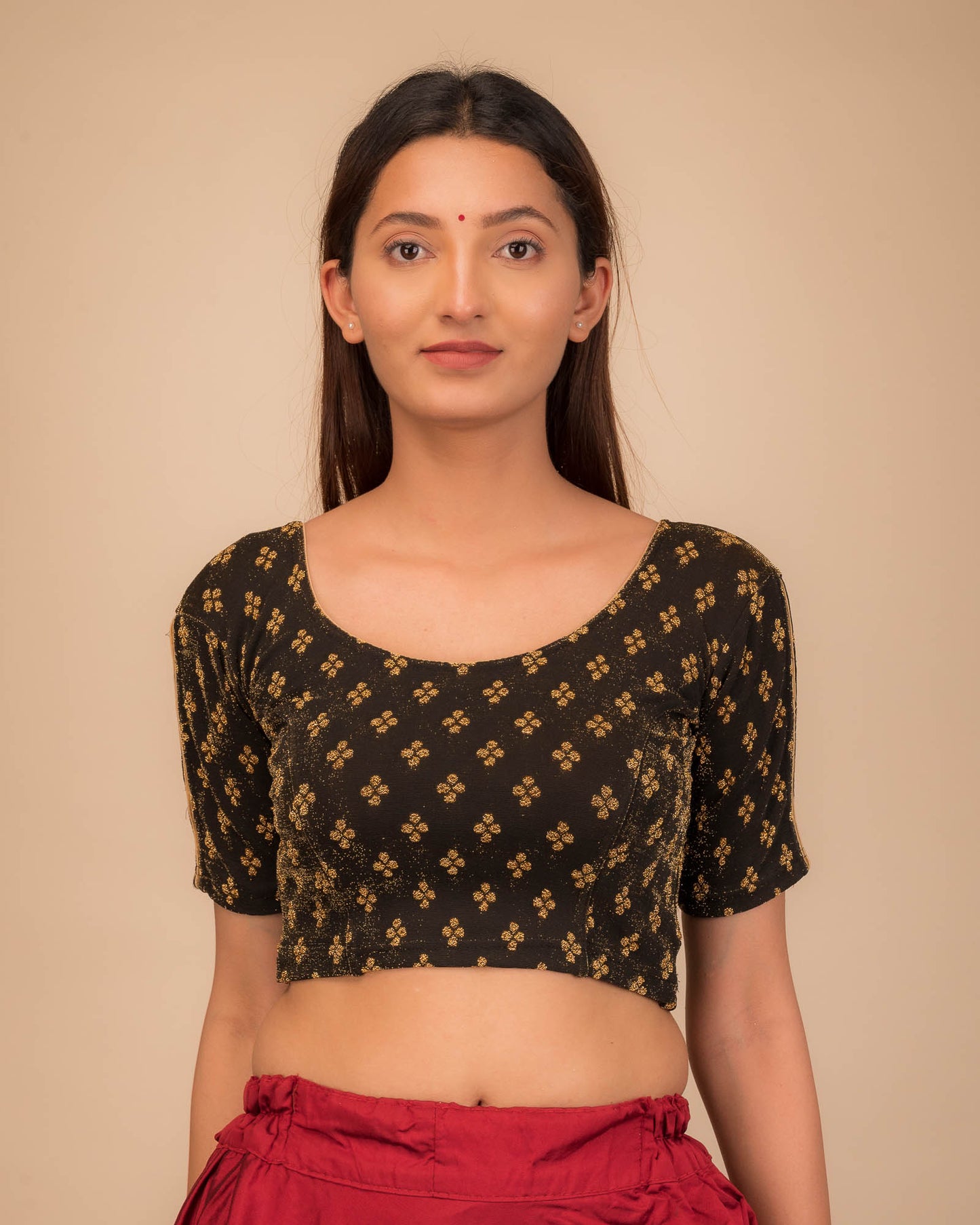 Model wearing a stretchable blouse with elbow sleeves and round neckline, showcasing buti motifs.
