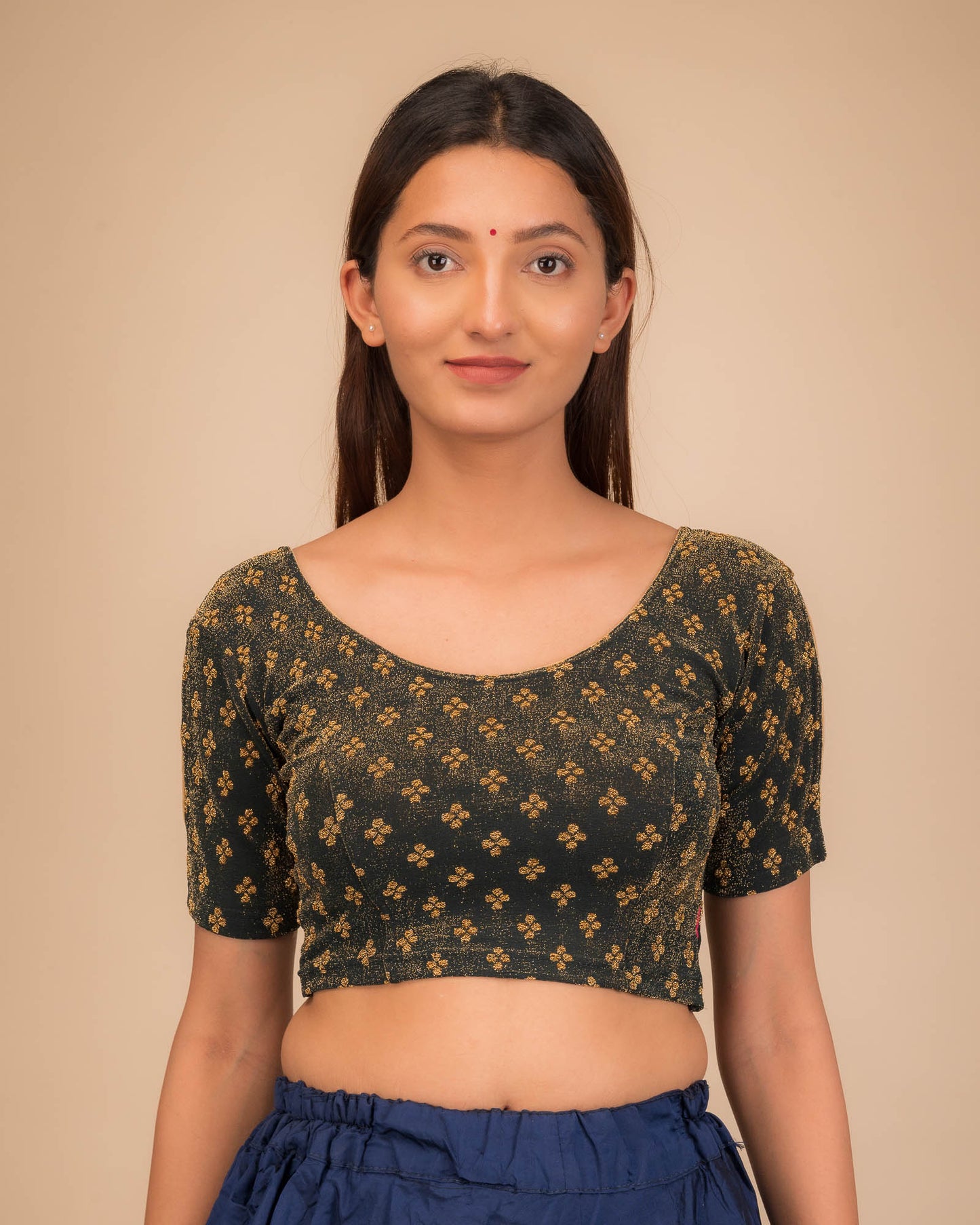 Model wearing a stretchable blouse with elbow sleeves and round neckline, showcasing buti motifs.