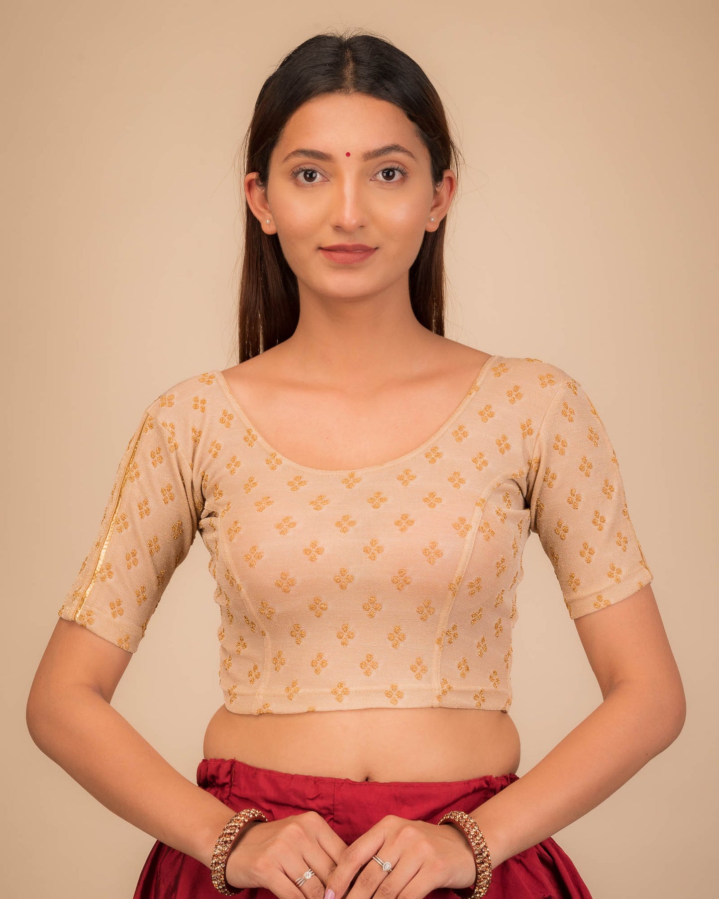 Model wearing a stretchable blouse with elbow sleeves and round neckline, showcasing buti motifs.