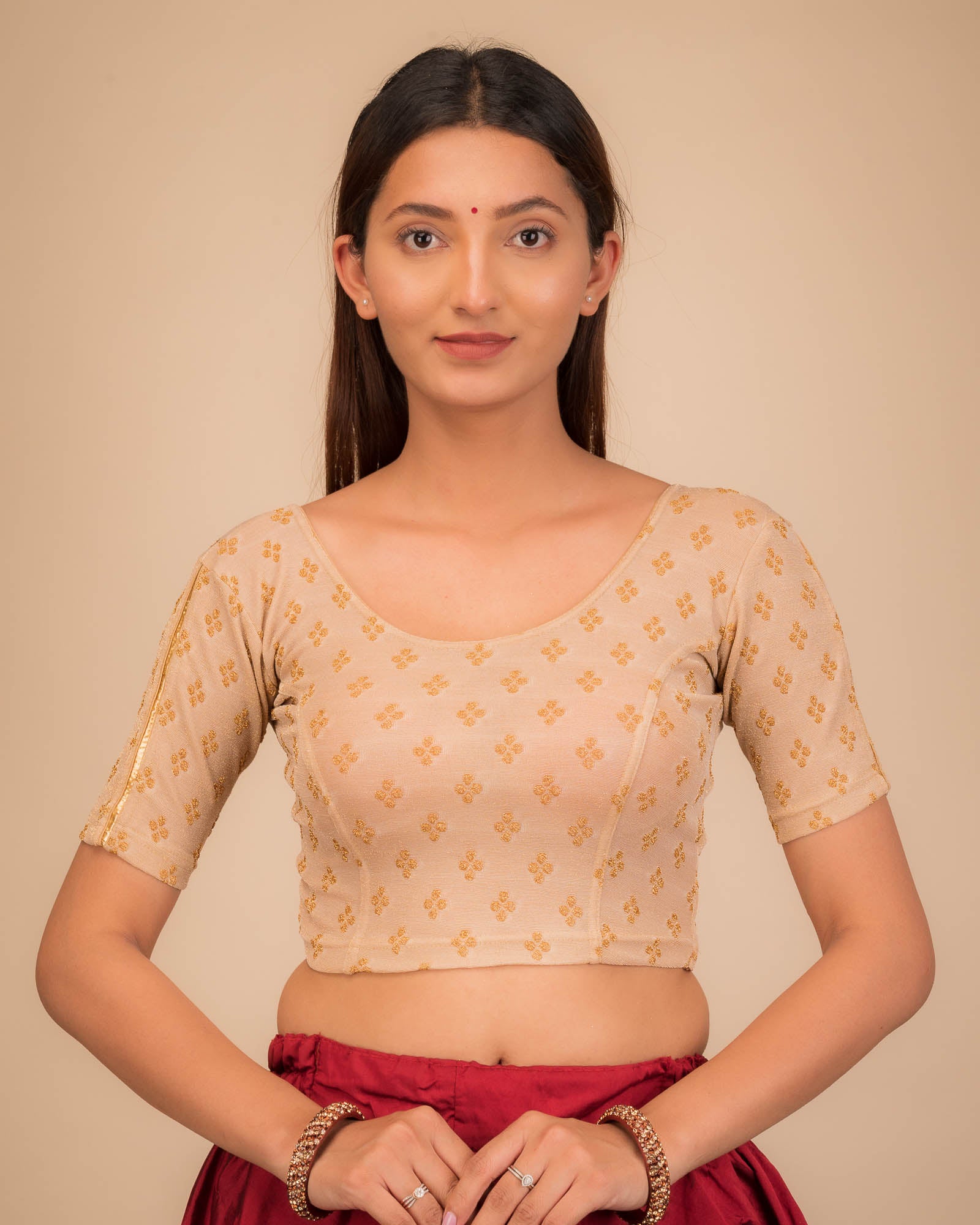 Model wearing a stretchable blouse with elbow sleeves and round neckline, showcasing buti motifs.