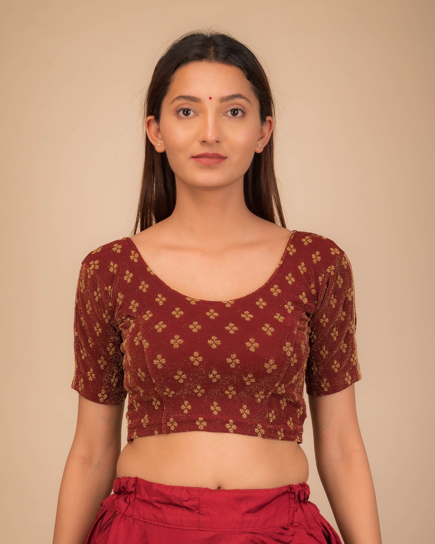 Model wearing a stretchable blouse with elbow sleeves and round neckline, showcasing buti motifs.