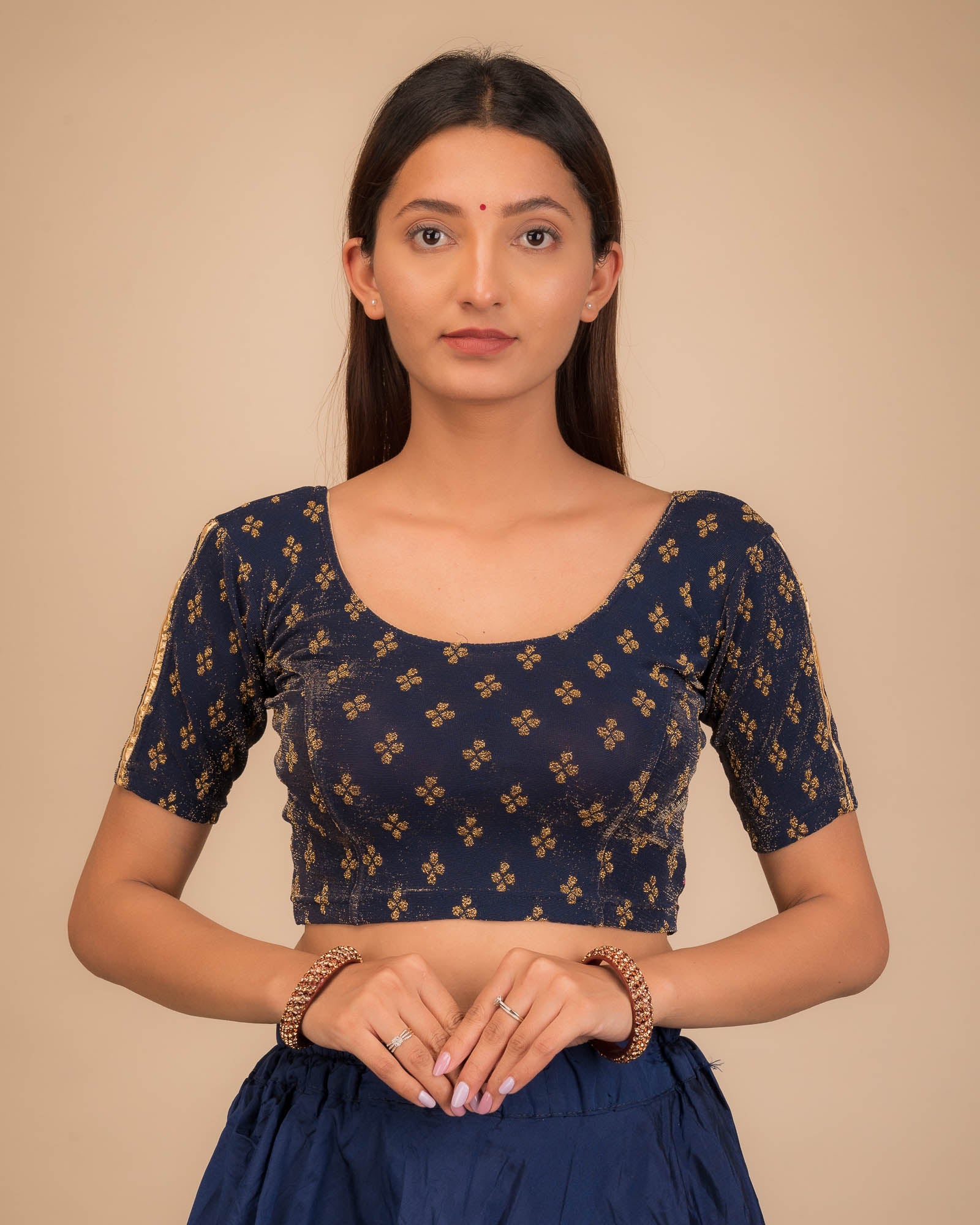 Model wearing a stretchable blouse with elbow sleeves and round neckline, showcasing buti motifs.