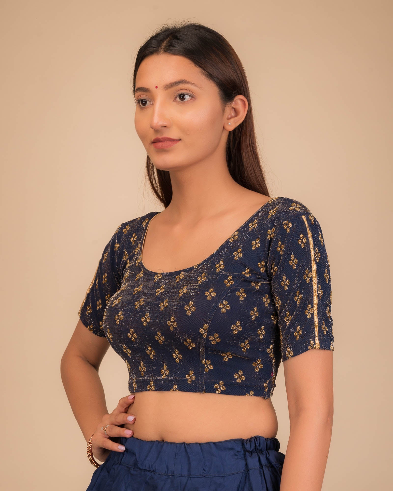 Side profile emphasizing the blouse’s fit and sleeve structure.