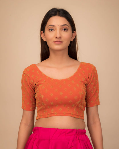 Model wearing a stretchable blouse with elbow sleeves and round neckline, showcasing buti motifs.