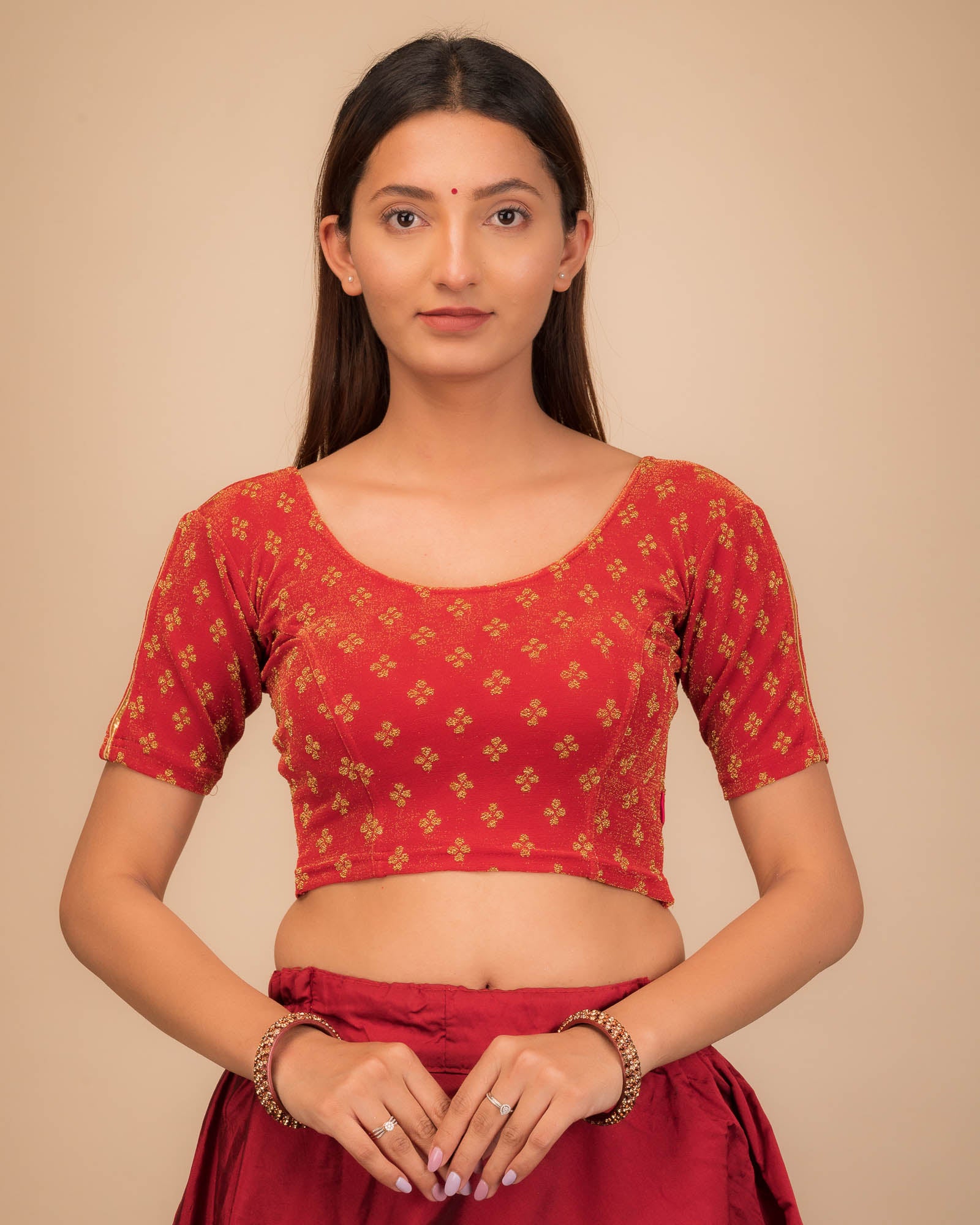 Model wearing a stretchable blouse with elbow sleeves and round neckline, showcasing buti motifs.