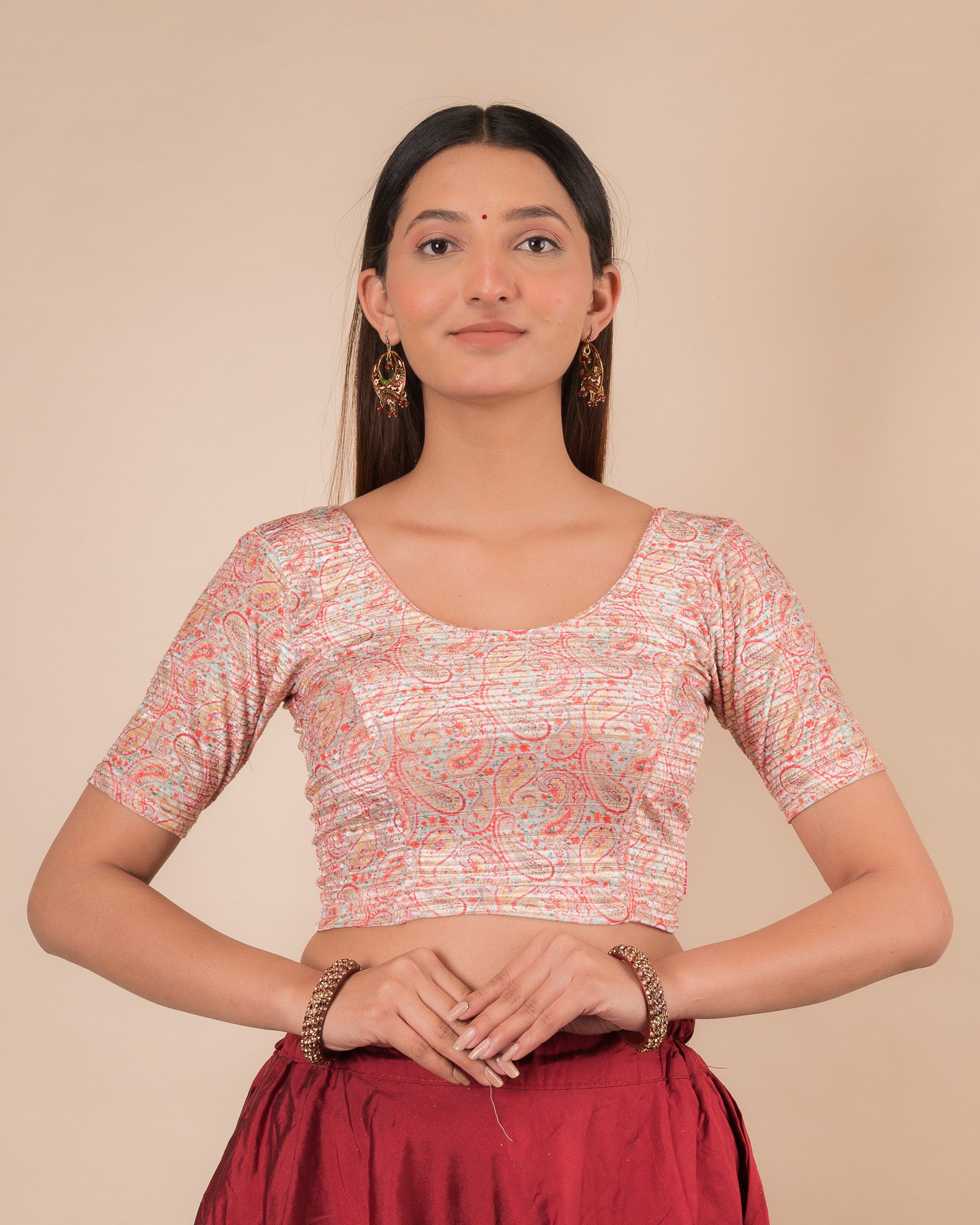 Model wearing a stretchable velvet blouse with elbow sleeves and round neckline, showcasing a floral print.
