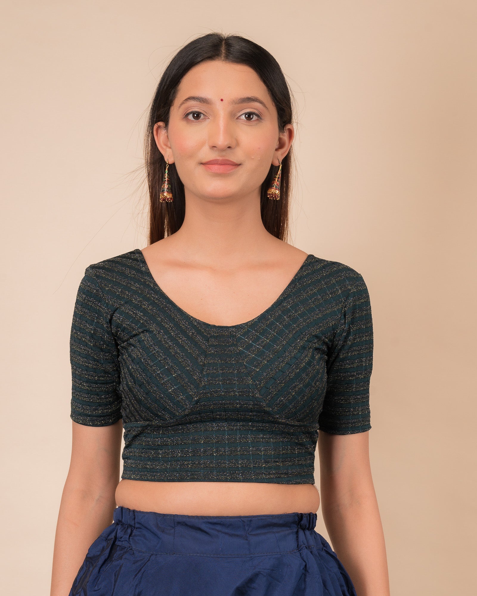 Model wearing a zari stripe stretchable readymade blouse with elbow sleeves and round neckline