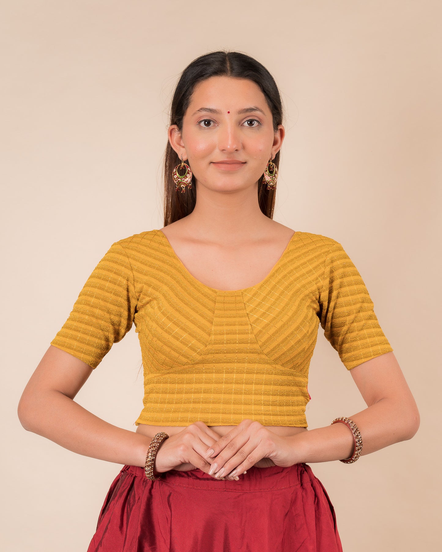 Model wearing a zari stripe stretchable readymade blouse with elbow sleeves and round neckline