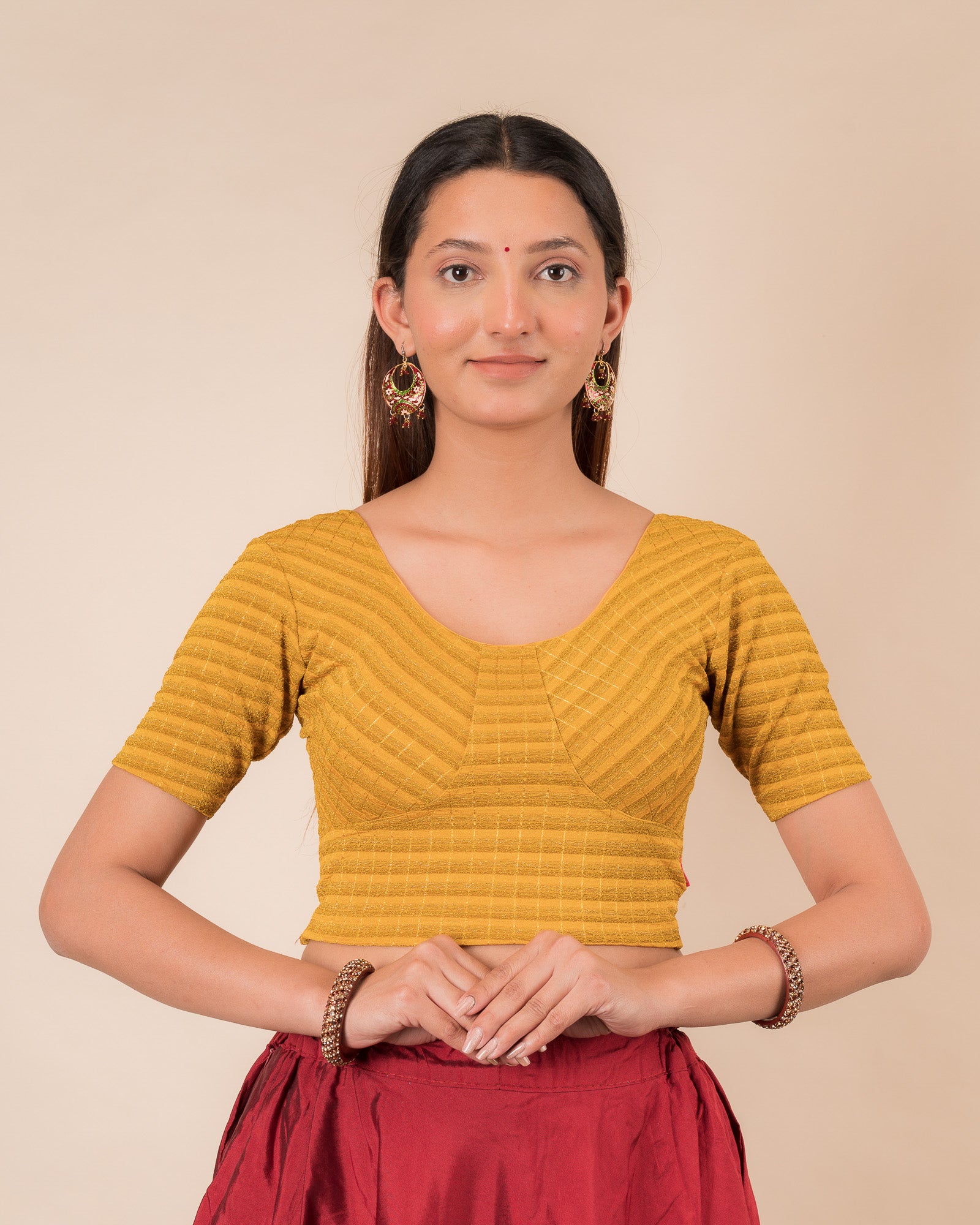 Model wearing a zari stripe stretchable readymade blouse with elbow sleeves and round neckline