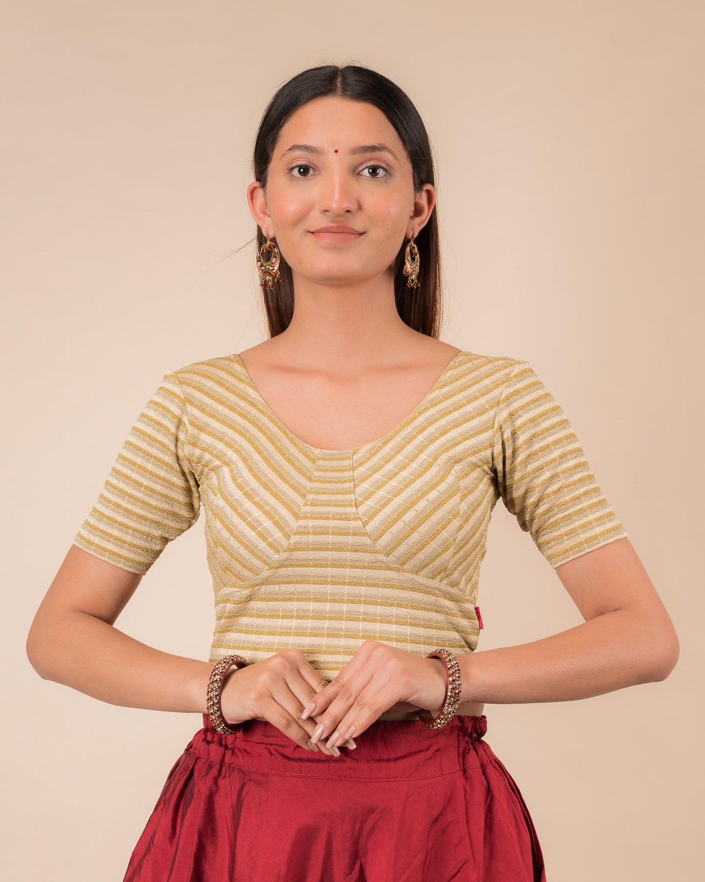 Model wearing a zari stripe stretchable readymade blouse with elbow sleeves and round neckline