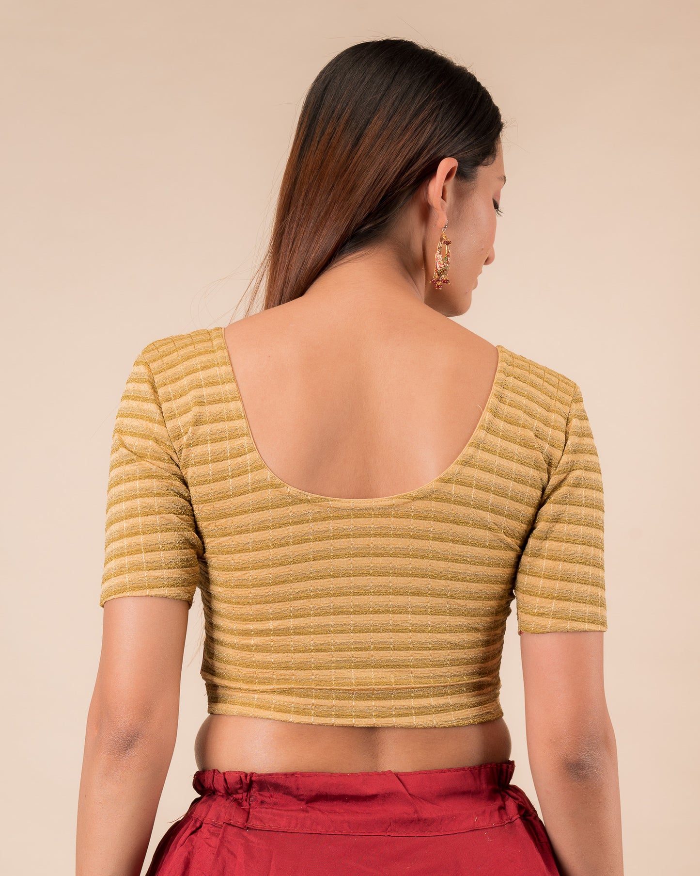 Rear view of the gold zari stripe stretchable blouse showcasing the back design