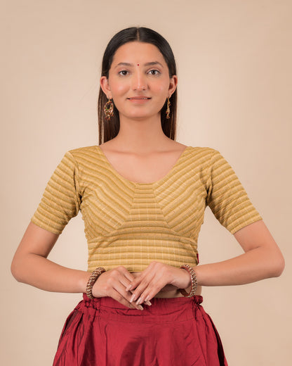 Model wearing a gold  zari stripe stretchable readymade blouse with elbow sleeves and round neckline