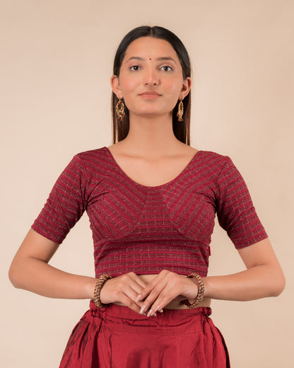 Model wearing a zari stripe stretchable readymade blouse with elbow sleeves and round neckline